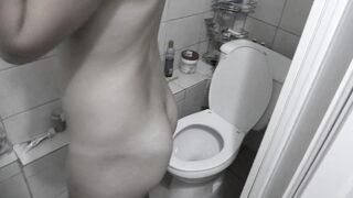 Toilet pissing slender mature blonde MILF with big booty and small tits.