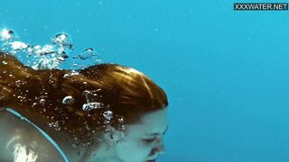 Underwater acrobatics in the pool with Mia Split