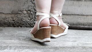 Chubby legs in high platform sandals.