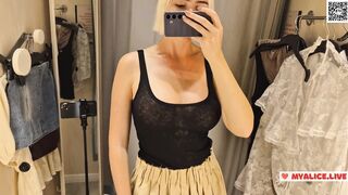 Trying on transparent clothes in the fitting room. Naked blonde flashed her boobs in a public place